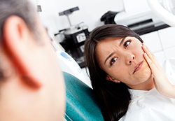 woman with tooth pain at the dentist with cavity Urbana, MD